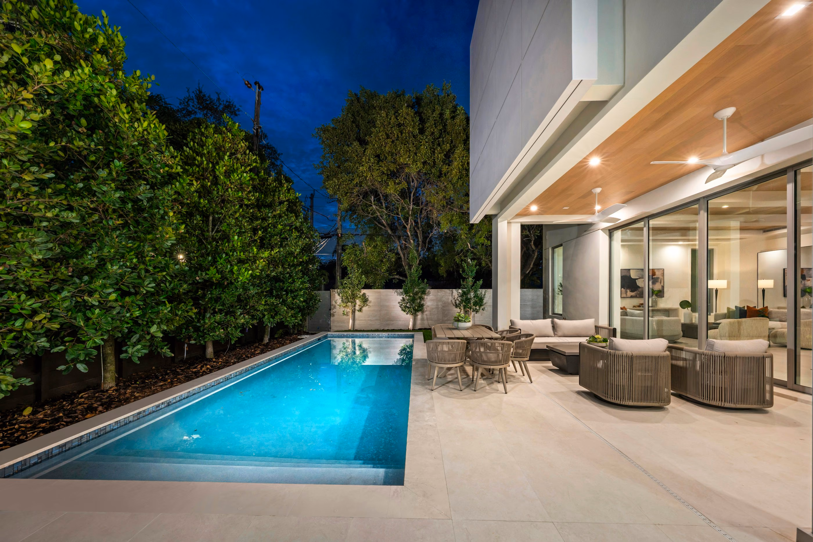 Terraced garden with a plunge pool and timber deck at dusk